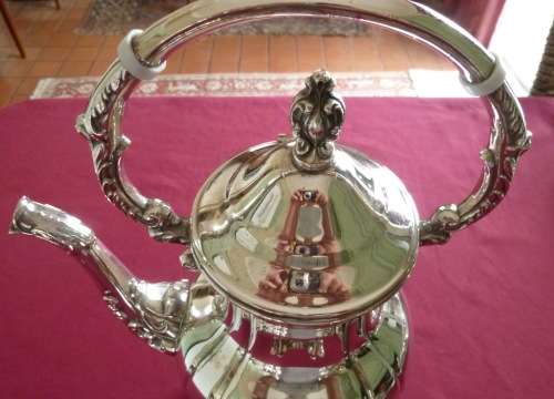 Silver plated tea kettle on stand