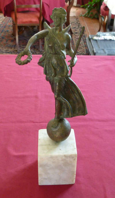 An attractive figure of a woman on a marble base