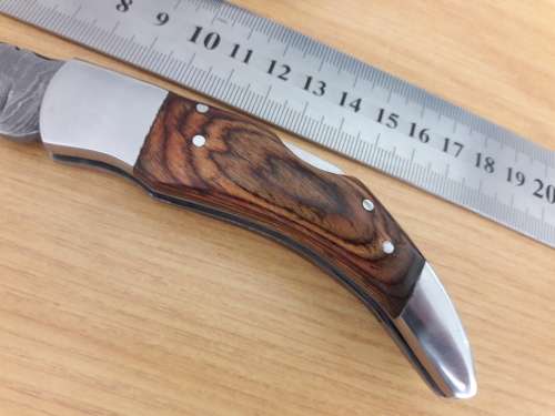 Handmade Damascus steel folding knife with Wooden handle scales.