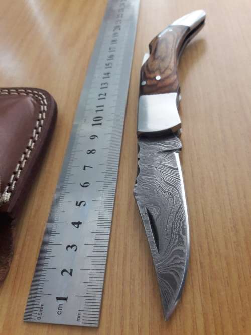 Handmade Damascus steel folding knife with Wooden handle scales.