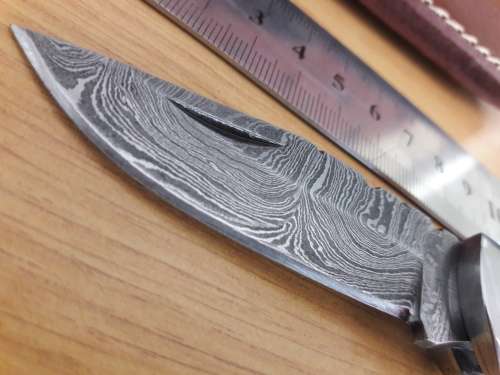 Handmade Damascus steel folding knife with Wooden handle scales.
