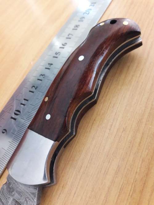 Handmade Damascus steel folding knife with Wooden handle scales.