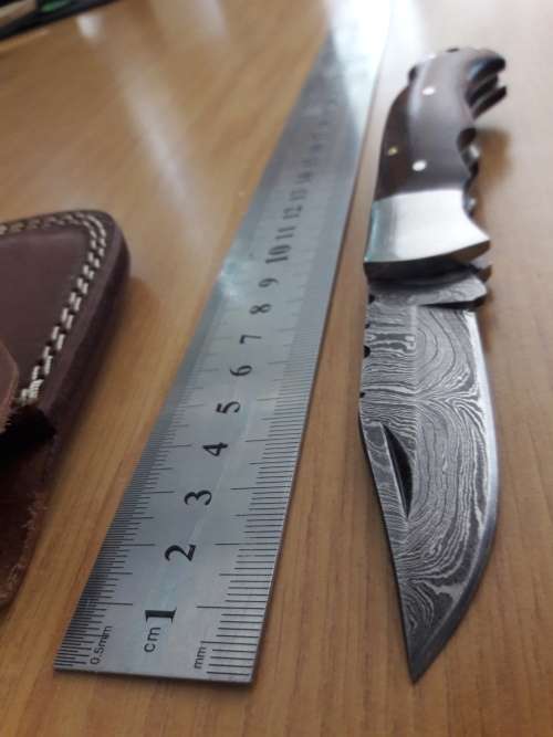 Handmade Damascus steel folding knife with Wooden handle scales.
