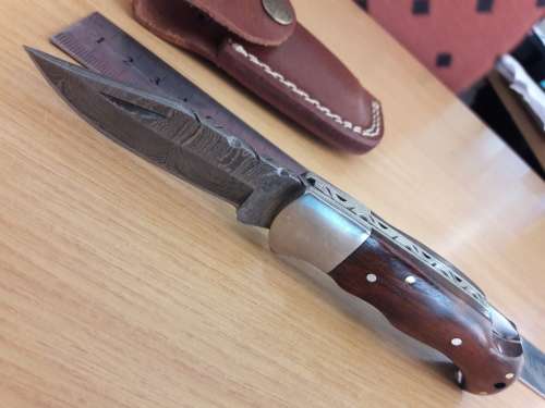 Handmade Damascus steel folding knife with Wooden handle scales.