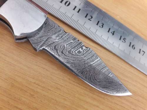 Handmade Damascus steel folding knife with Wooden handle scales.