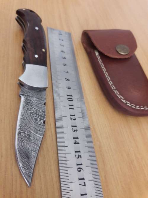 Handmade Damascus steel folding knife with Wooden handle scales.