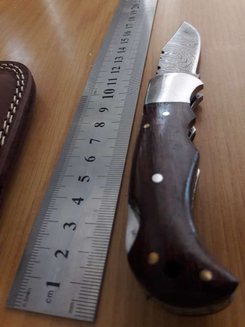 Handmade Damascus steel folding knife with Wooden handle scales.