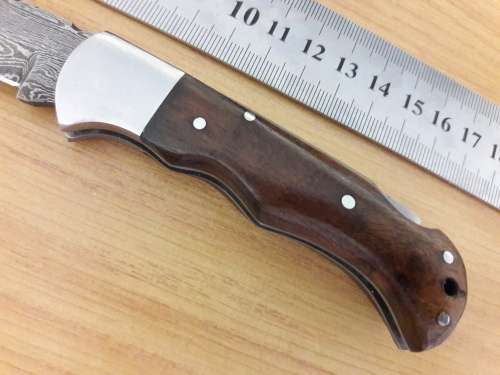 Handmade Damascus steel folding knife with Wooden handle scales.