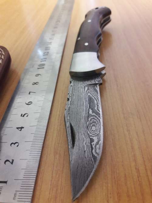 Handmade Damascus steel folding knife with Wooden handle scales.
