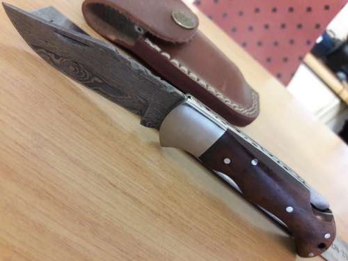 Handmade Damascus steel folding knife with Wooden handle scales.