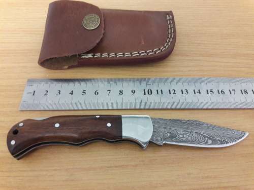 Handmade Damascus steel folding knife with Wooden handle scales.