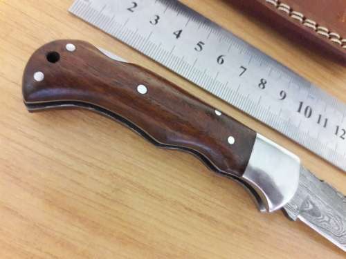 Handmade Damascus steel folding knife with Wooden handle scales.