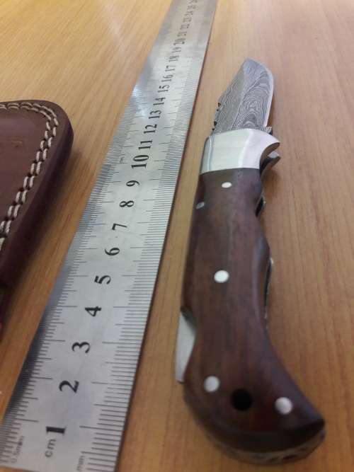 Handmade Damascus steel folding knife with Wooden handle scales.