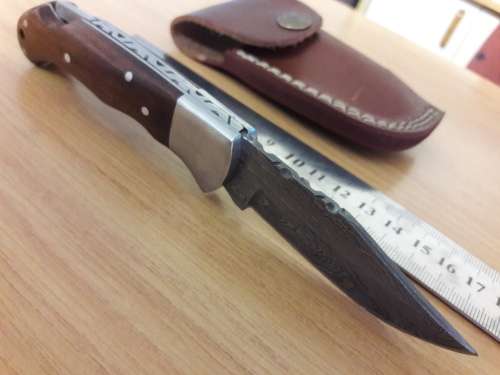 Handmade Damascus steel folding knife with Wooden handle scales.