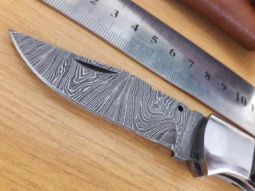 Handmade Damascus steel folding knife with BULL HORN handle scales.