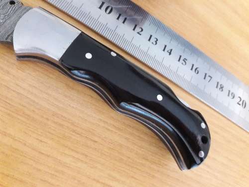 Handmade Damascus steel folding knife with BULL HORN handle scales.