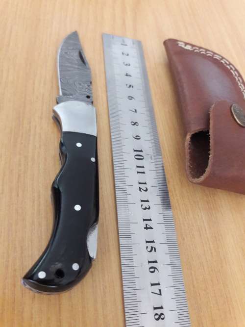 Handmade Damascus steel folding knife with BULL HORN handle scales.