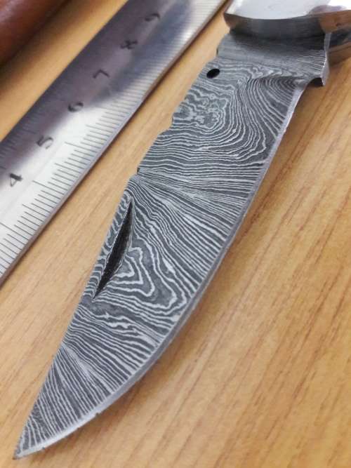 Handmade Damascus steel folding knife with BULL HORN handle scales.