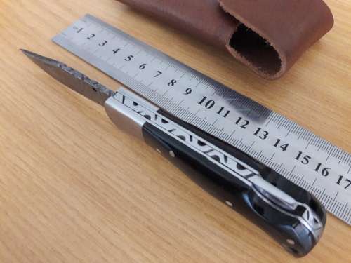 Handmade Damascus steel folding knife with BULL HORN handle scales.