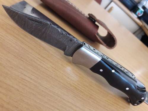Handmade Damascus steel folding knife with BULL HORN handle scales.