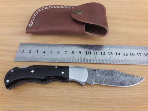 Handmade Damascus steel folding knife with BULL HORN handle scales.