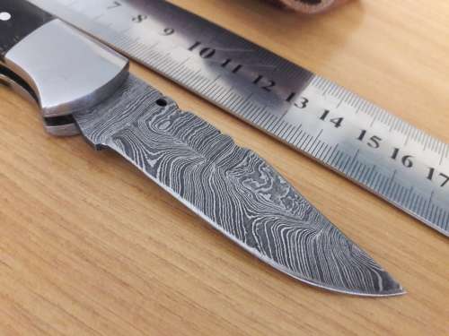Handmade Damascus steel folding knife with BULL HORN handle scales.