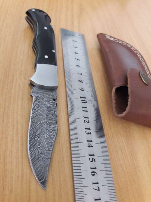 Handmade Damascus steel folding knife with BULL HORN handle scales.