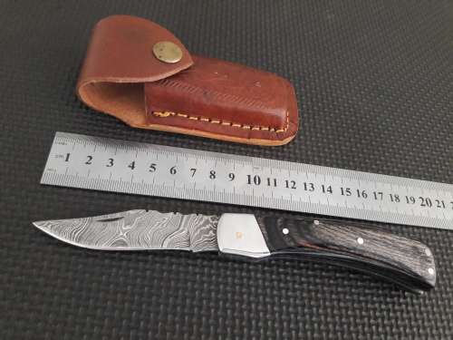 Handmade Damascus steel folding knife with Wooden handle scales.