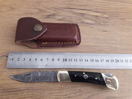 Handmade Damascus steel folding knife with Bull Horn handle scales.
