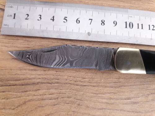 Handmade Damascus steel folding knife with Bull Horn handle scales.