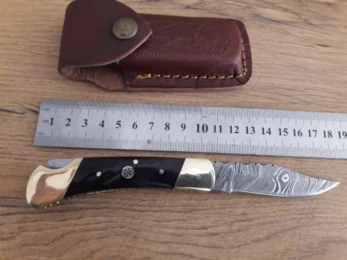 Handmade Damascus steel folding knife with Bull Horn handle scales.