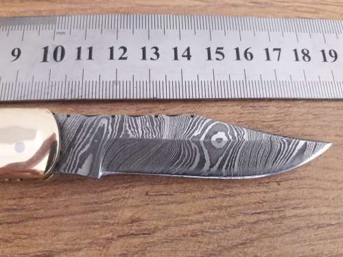 Handmade Damascus steel folding knife with Bull Horn handle scales.