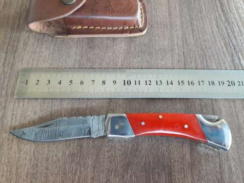 Handmade Damascus steel folding knife with Resin handle scales.