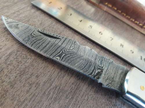 Handmade Damascus steel folding knife with Resin handle scales.
