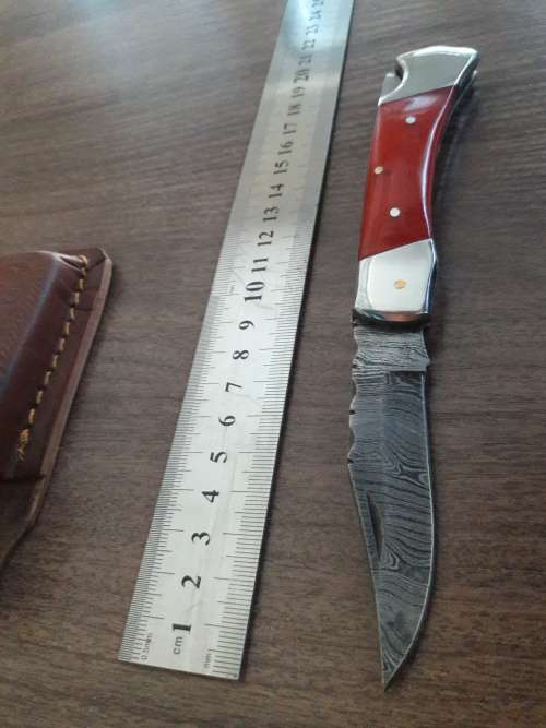Handmade Damascus steel folding knife with Resin handle scales.