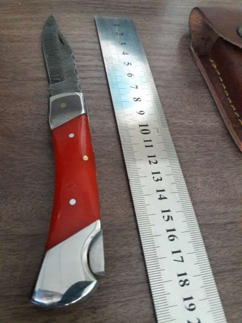 Handmade Damascus steel folding knife with Resin handle scales.