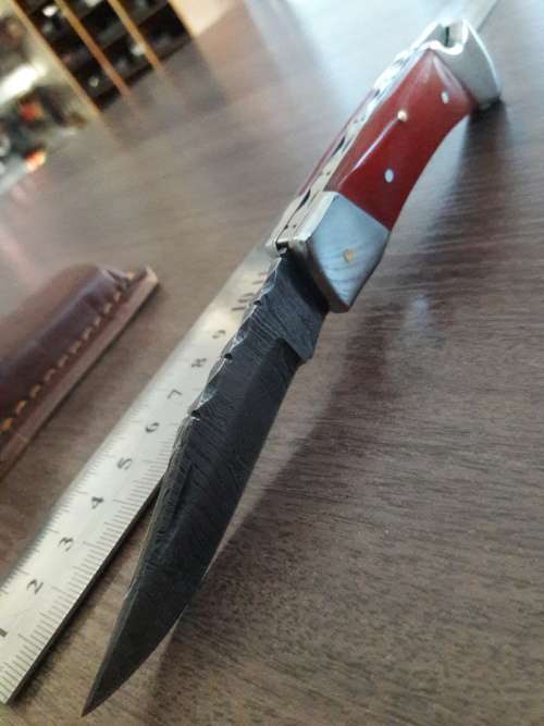 Handmade Damascus steel folding knife with Resin handle scales.