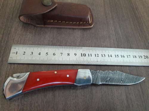 Handmade Damascus steel folding knife with Resin handle scales.