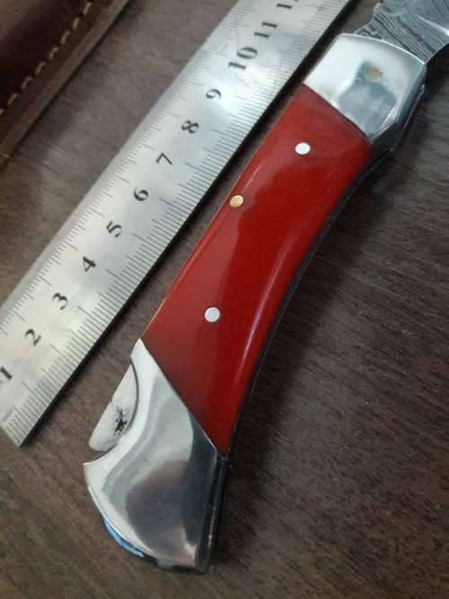 Handmade Damascus steel folding knife with Resin handle scales.