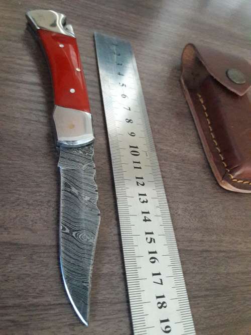 Handmade Damascus steel folding knife with Resin handle scales.