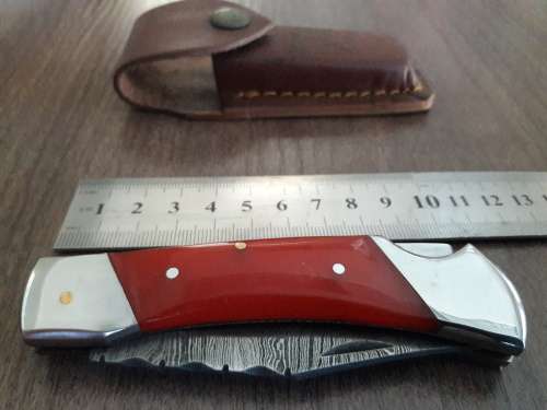 Handmade Damascus steel folding knife with Resin handle scales.