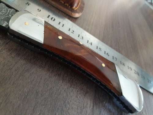 Handmade Damascus steel folding knife with Resin handle scales.