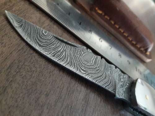 Handmade Damascus steel folding knife with Resin handle scales.