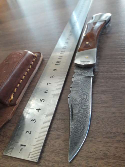 Handmade Damascus steel folding knife with Resin handle scales.