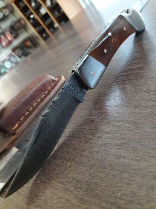 Handmade Damascus steel folding knife with Resin handle scales.