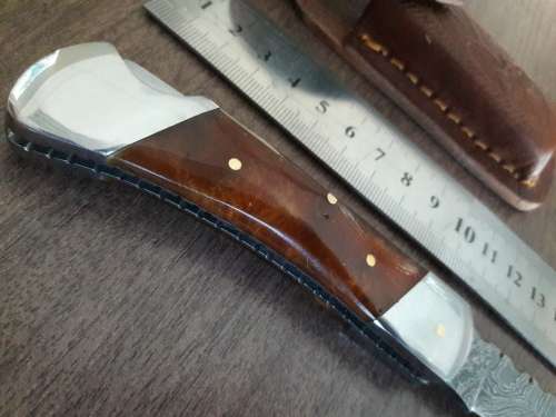 Handmade Damascus steel folding knife with Resin handle scales.
