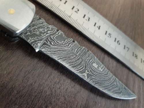 Handmade Damascus steel folding knife with Resin handle scales.