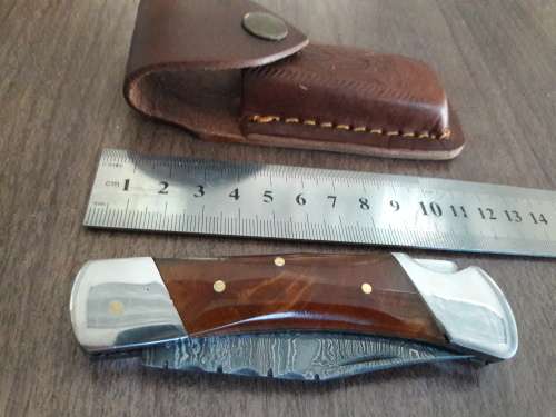 Handmade Damascus steel folding knife with Resin handle scales.