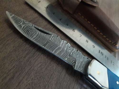 Handmade Damascus steel folding knife with Resin handle scales.