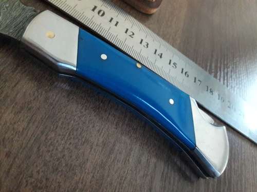 Handmade Damascus steel folding knife with Resin handle scales.